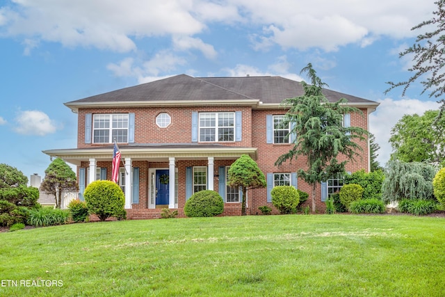 4913 Ivy Rose Dr, Knoxville, TN 37918 - colonial house with brick siding, a front yard, and a porch