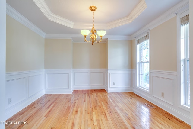 4913 Ivy Rose Dr, Knoxville, TN 37918 - spare room featuring light wood finished floors, a tray ceiling, a chandelier, wainscoting, and crown molding