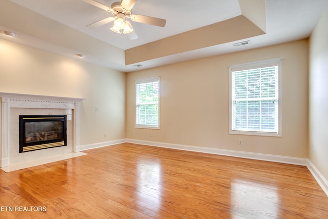 4913 Ivy Rose Dr, Knoxville, TN 37918 - unfurnished living room with wood finished floors, a tile fireplace, baseboards, and a ceiling fan