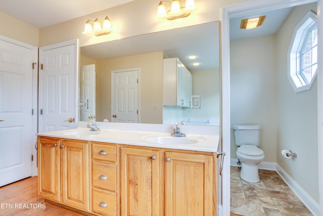 4913 Ivy Rose Dr, Knoxville, TN 37918 - bathroom featuring double vanity, toilet, and baseboards