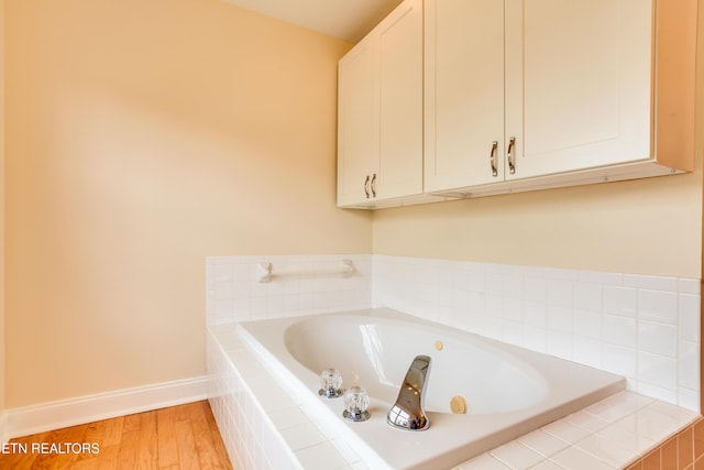 4913 Ivy Rose Dr, Knoxville, TN 37918 - full bathroom featuring a garden tub, wood finished floors, and baseboards