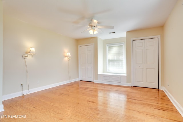 4913 Ivy Rose Dr, Knoxville, TN 37918 - unfurnished bedroom with two closets, light wood-type flooring, baseboards, and a ceiling fan