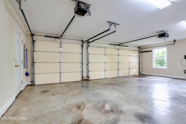 4913 Ivy Rose Dr, Knoxville, TN 37918 - garage featuring a garage door opener and baseboards