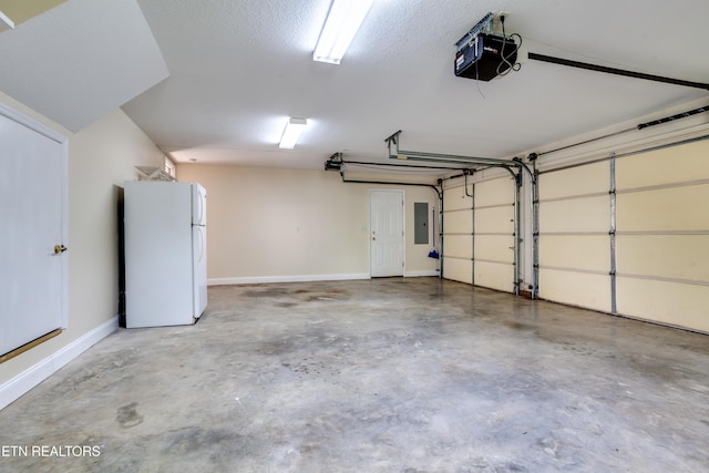 4913 Ivy Rose Dr, Knoxville, TN 37918 - garage featuring freestanding refrigerator, a garage door opener, electric panel, and baseboards