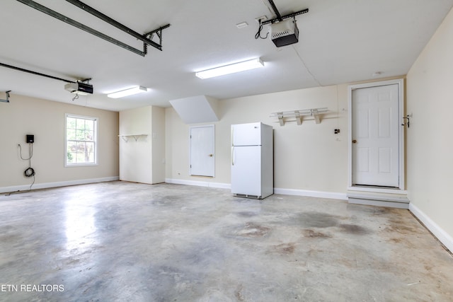 4913 Ivy Rose Dr, Knoxville, TN 37918 - garage featuring freestanding refrigerator and a garage door opener