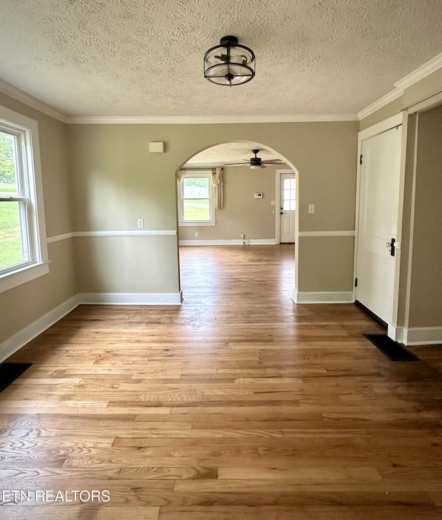 503 S Ruth St, Maryville, TN 37803 - spare room featuring arched walkways, a textured ceiling, crown molding, wood finished floors, and baseboards