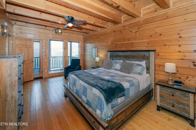 1032 Black Bear Cub Way, Sevierville, TN 37862 - bedroom with beam ceiling, light wood-type flooring, wood walls, and access to exterior