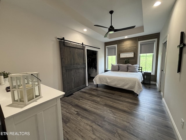 3152 Bridgewater Blvd, Morristown, TN 37814 - bedroom featuring a barn door, dark wood finished floors, recessed lighting, baseboards, and a raised ceiling