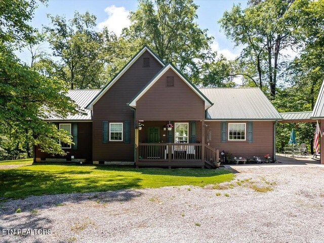 3428 Connie Ln, White Pine, TN 37890 - view of front facade featuring covered porch, metal roof, and a front yard