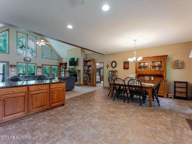 3428 Connie Ln, White Pine, TN 37890 - dining space with a fireplace, a chandelier, stone finish floors, a ceiling fan, and vaulted ceiling