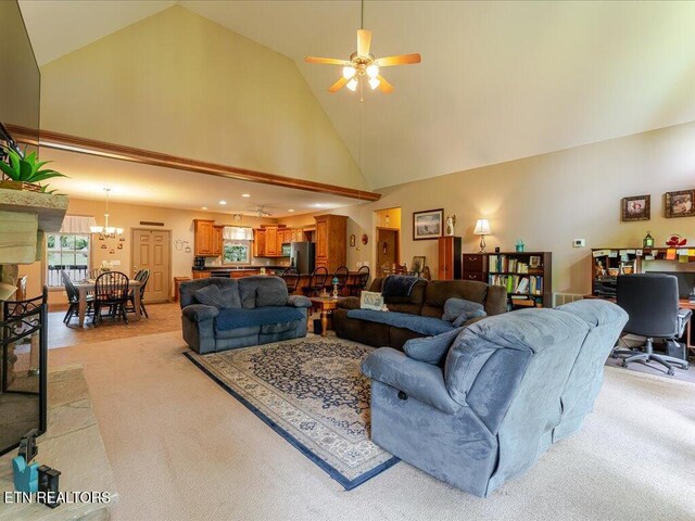 3428 Connie Ln, White Pine, TN 37890 - living room with high vaulted ceiling, light carpet, a ceiling fan, and a chandelier