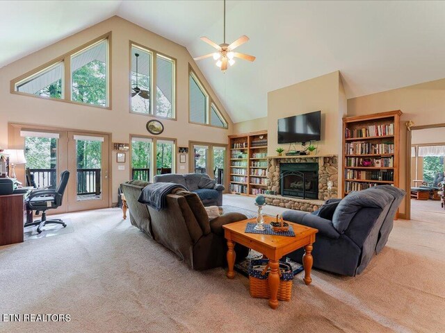 3428 Connie Ln, White Pine, TN 37890 - living room with light colored carpet, a ceiling fan, high vaulted ceiling, a stone fireplace, and a desk