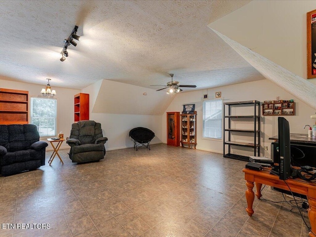 3428 Connie Ln, White Pine, TN 37890 - living area featuring a textured ceiling, ceiling fan, a chandelier, vaulted ceiling, and baseboards
