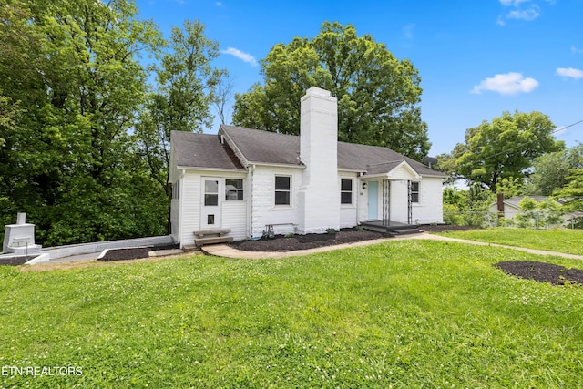 308 Nash Rd, Knoxville, TN 37914 - ranch-style house featuring a chimney, a front lawn, entry steps, and a shingled roof