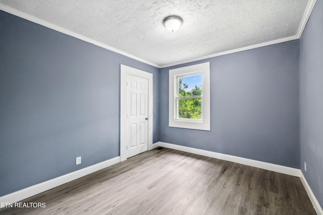 308 Nash Rd, Knoxville, TN 37914 - spare room featuring a textured ceiling, wood finished floors, baseboards, and crown molding
