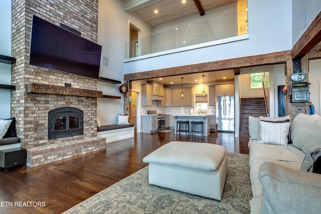 1510 Hickory Pointe Ln, Maynardville, TN 37807 - living area with a towering ceiling, dark wood finished floors, beamed ceiling, a brick fireplace, and stairs