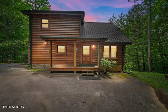 view of front of home featuring covered porch and metal roof