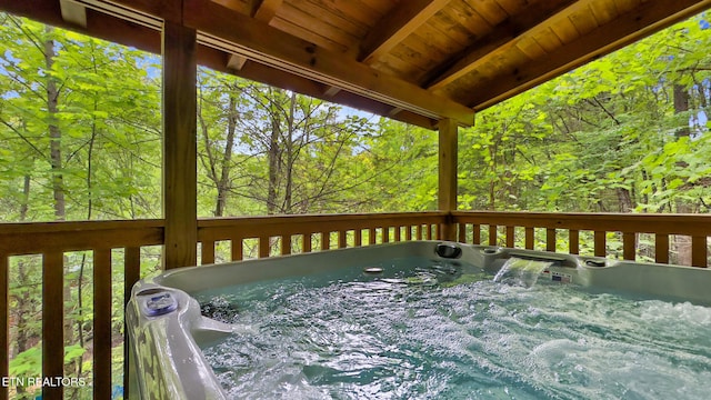 wooden deck with a hot tub