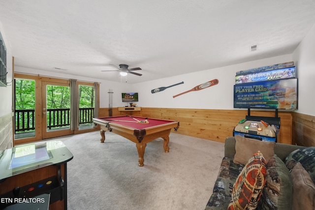 rec room featuring pool table, carpet floors, a wainscoted wall, wooden walls, and a ceiling fan