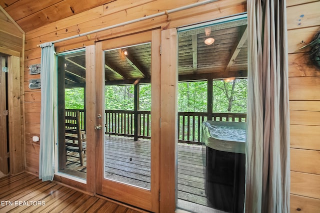 entryway featuring wooden walls, vaulted ceiling, wood finished floors, and wooden ceiling