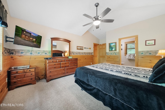 bedroom featuring lofted ceiling, carpet flooring, wood walls, wainscoting, and a ceiling fan