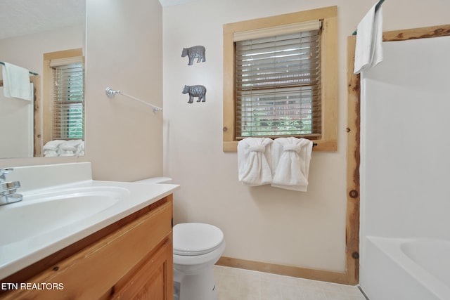 full bath with a shower, baseboards, vanity, toilet, and a tub to relax in