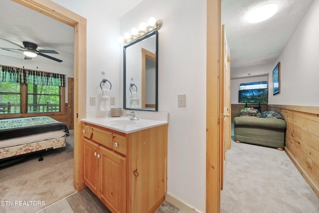 bathroom featuring connected bathroom, ceiling fan, vanity, and a textured ceiling