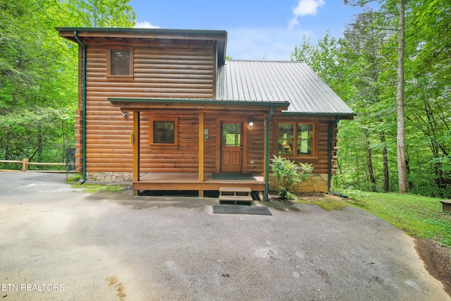 view of front of property featuring covered porch and metal roof