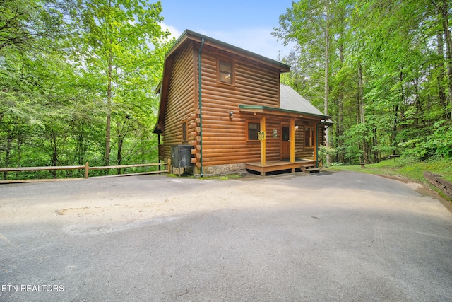 view of front of house with a porch and faux log siding