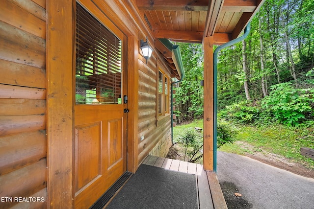 doorway to property with log veneer siding