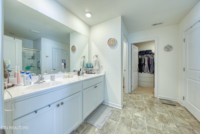 162 Harbour Pointe Ln, Oak Ridge, TN 37830 - full bath featuring baseboards, a stall shower, double vanity, a spacious closet, and stone finish flooring
