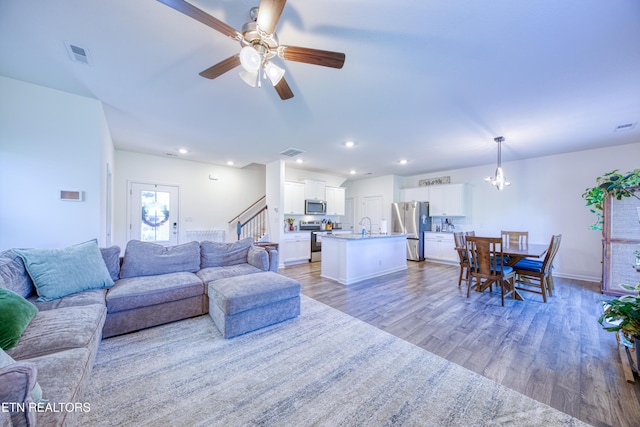 162 Harbour Pointe Ln, Oak Ridge, TN 37830 - living area with wood finished floors, ceiling fan, a chandelier, stairs, and recessed lighting