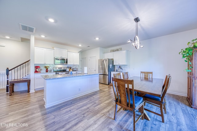162 Harbour Pointe Ln, Oak Ridge, TN 37830 - dining area with light wood-style floors, a chandelier, recessed lighting, baseboards, and stairway