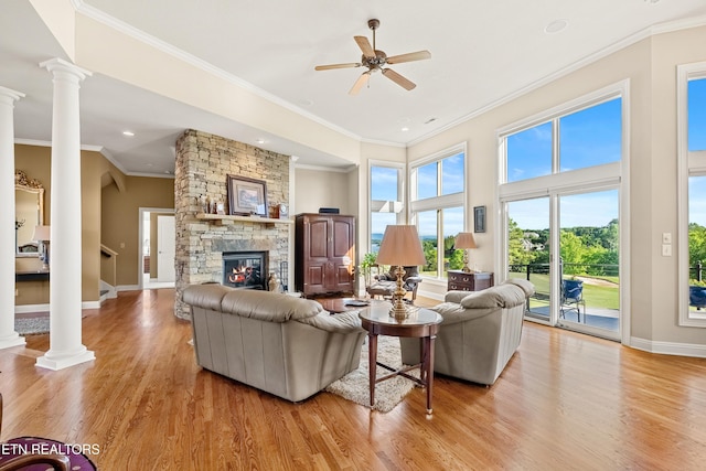 170 Blue Jay Ave, Vonore, TN 37885 - living area with decorative columns, light wood-style floors, a stone fireplace, ceiling fan, and ornamental molding