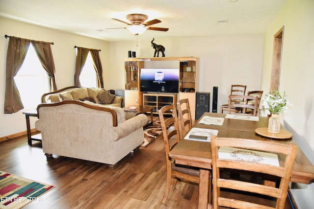 dining space with ceiling fan and wood finished floors