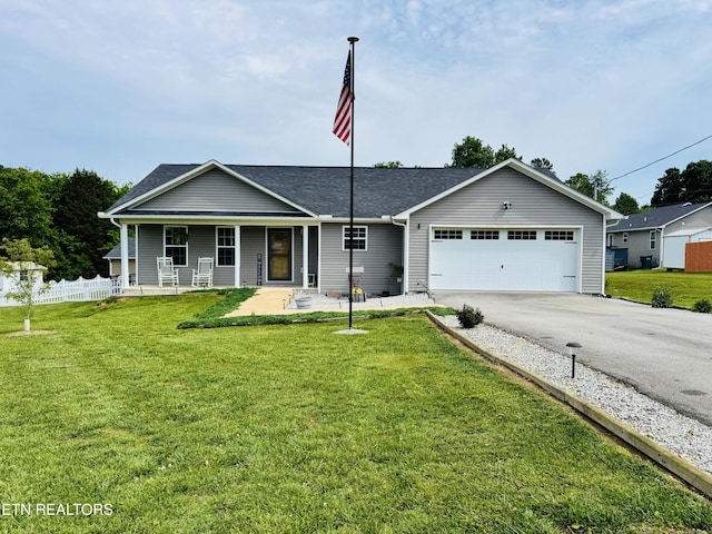 ranch-style home with asphalt driveway, an attached garage, a porch, and roof with shingles