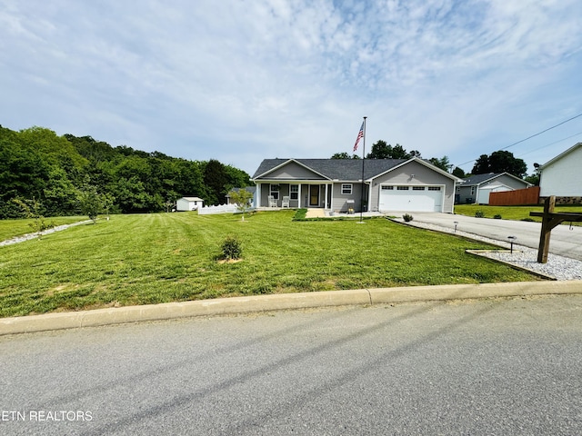 ranch-style home with driveway, an attached garage, a porch, and a storage unit