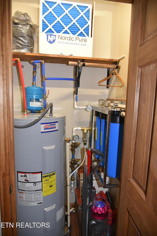 utility room featuring water heater
