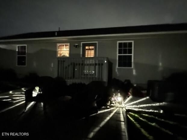 view of back of house at night