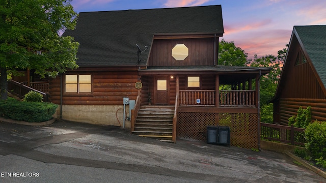2006 Cougar Crossing Way, Sevierville, TN 37862 - log-style house featuring covered porch, log exterior, roof with shingles, and stairs