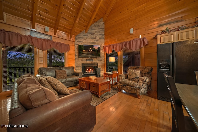 2006 Cougar Crossing Way, Sevierville, TN 37862 - living room with wood ceiling, wood-type flooring, beam ceiling, wood walls, and a stone fireplace