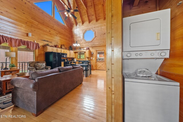 2006 Cougar Crossing Way, Sevierville, TN 37862 - living area featuring wood walls, estacked washer and dryer, high vaulted ceiling, plenty of natural light, and a ceiling fan