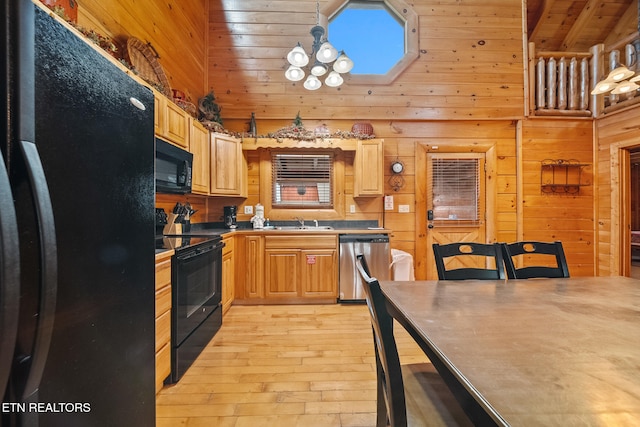 2006 Cougar Crossing Way, Sevierville, TN 37862 - kitchen featuring black appliances, light wood-type flooring, wooden walls, a sink, and high vaulted ceiling