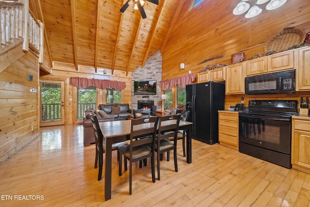 2006 Cougar Crossing Way, Sevierville, TN 37862 - dining room featuring high vaulted ceiling, wooden walls, healthy amount of natural light, light wood finished floors, and a stone fireplace