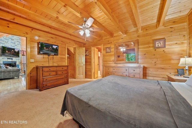 2006 Cougar Crossing Way, Sevierville, TN 37862 - bedroom featuring beamed ceiling, wood walls, carpet, wooden ceiling, and a stone fireplace