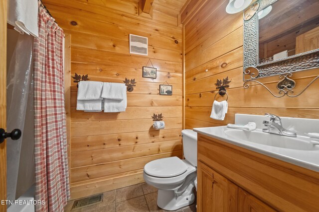 2006 Cougar Crossing Way, Sevierville, TN 37862 - bathroom with tile patterned flooring, toilet, wooden walls, vanity, and curtained shower