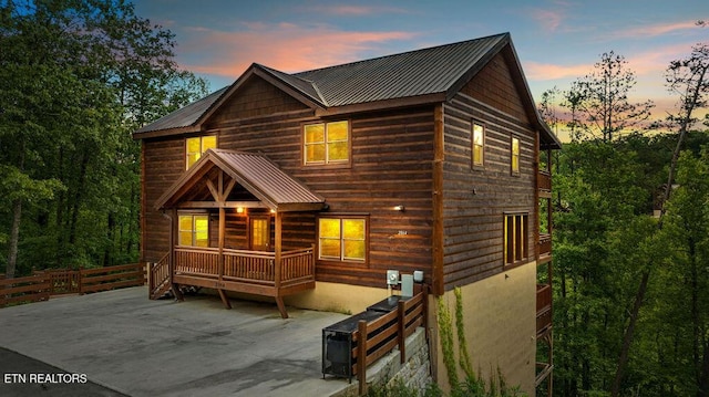chalet / cabin featuring metal roof and a patio