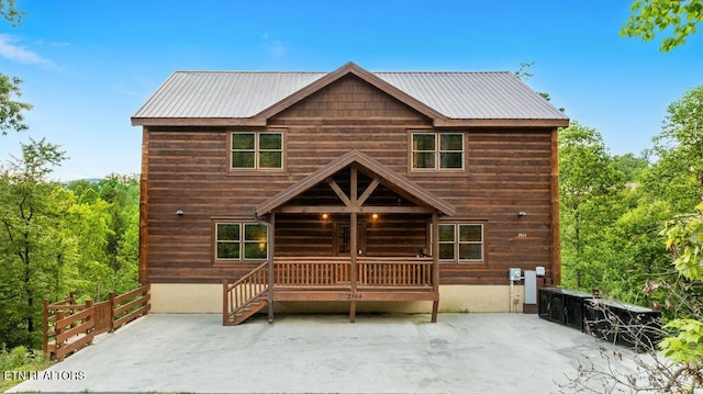 view of front of property with a patio area and metal roof
