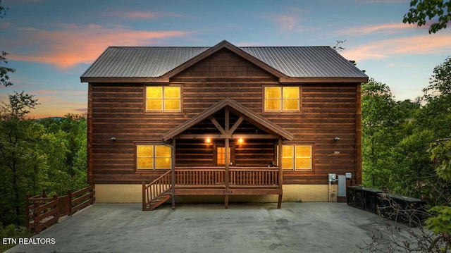 view of front of home with a patio and metal roof