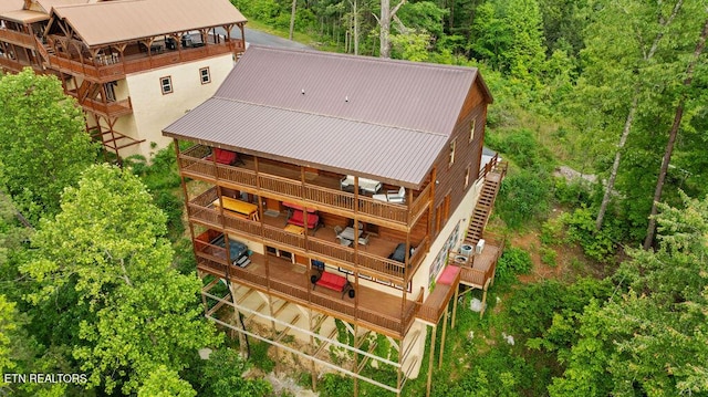 aerial view of property and surrounding area featuring a heavily wooded area